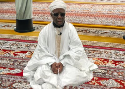 Sheikh Momoh sitting with prayer beads